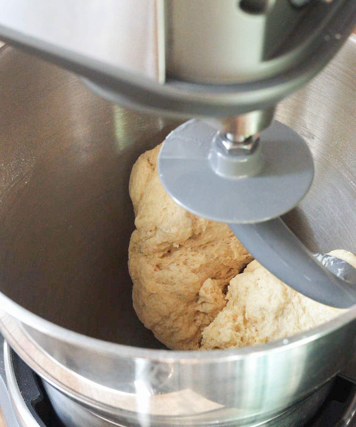 Wet and dry ingredients mixed together in a bowl to form a thick dough.