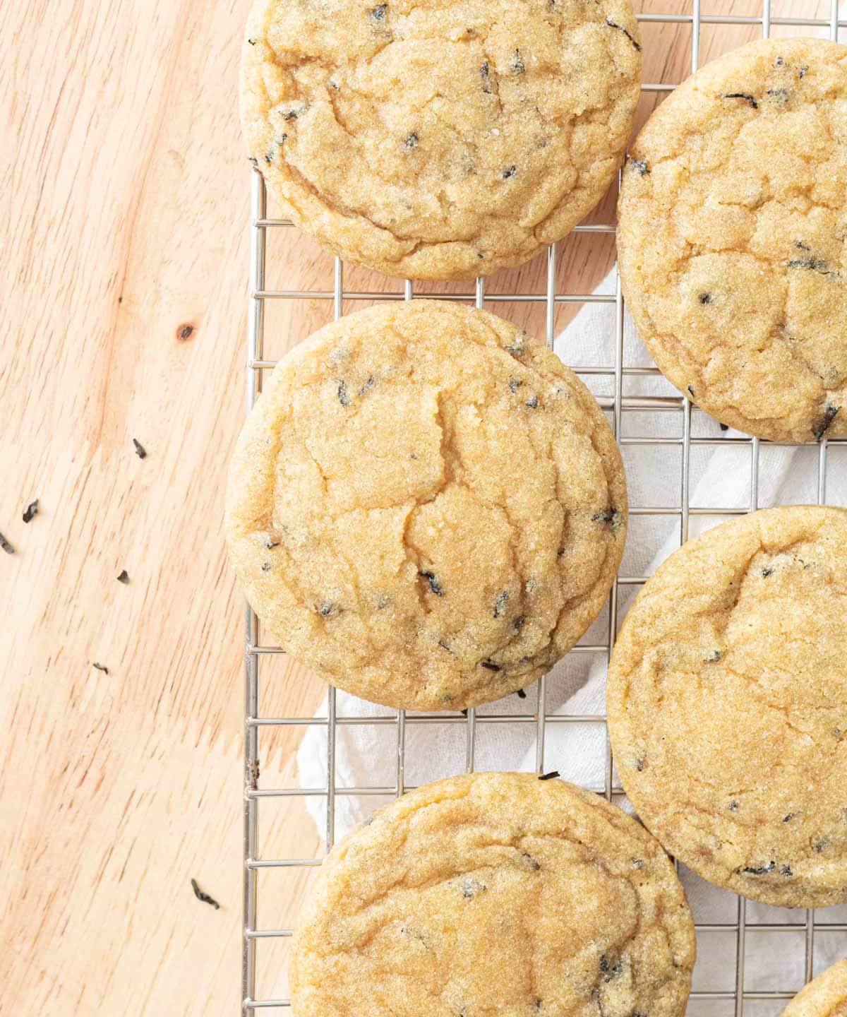 Freshly baked earl grey cookies on a wire rack.