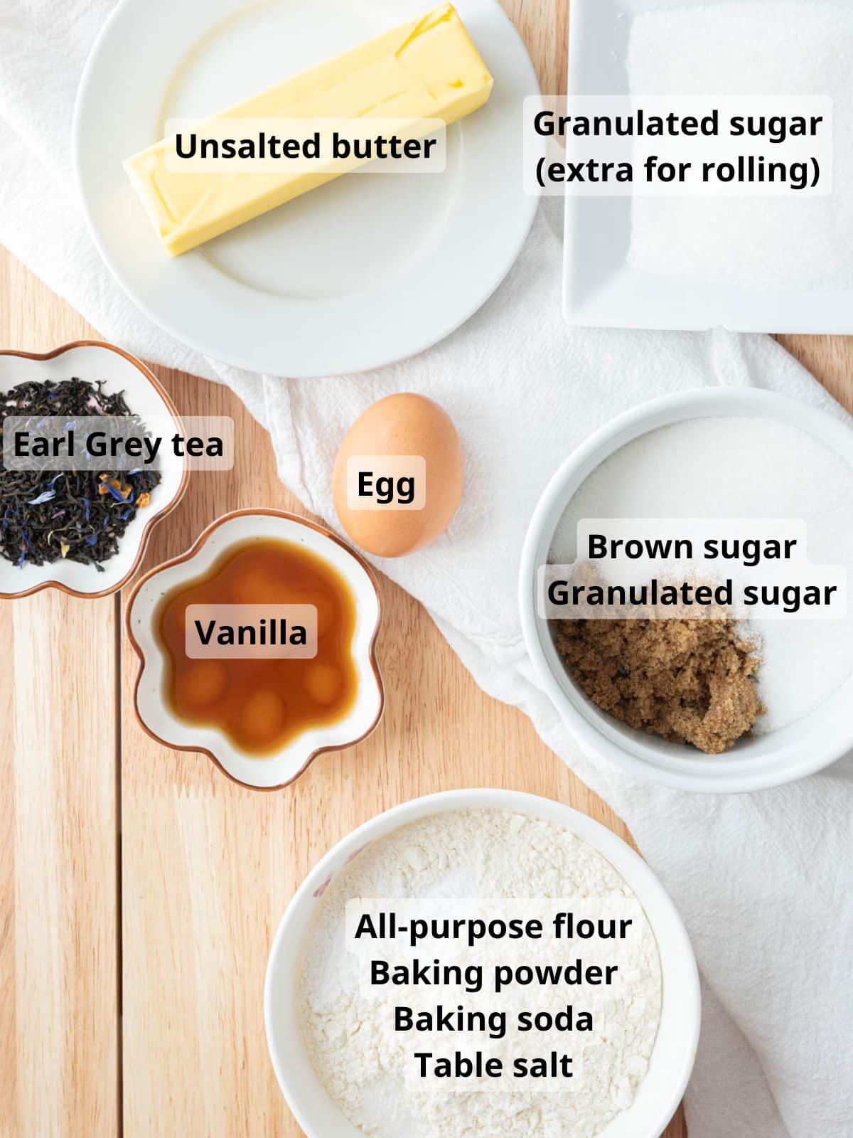 Earl grey sugar cookie ingredients laid out on a table with labels.