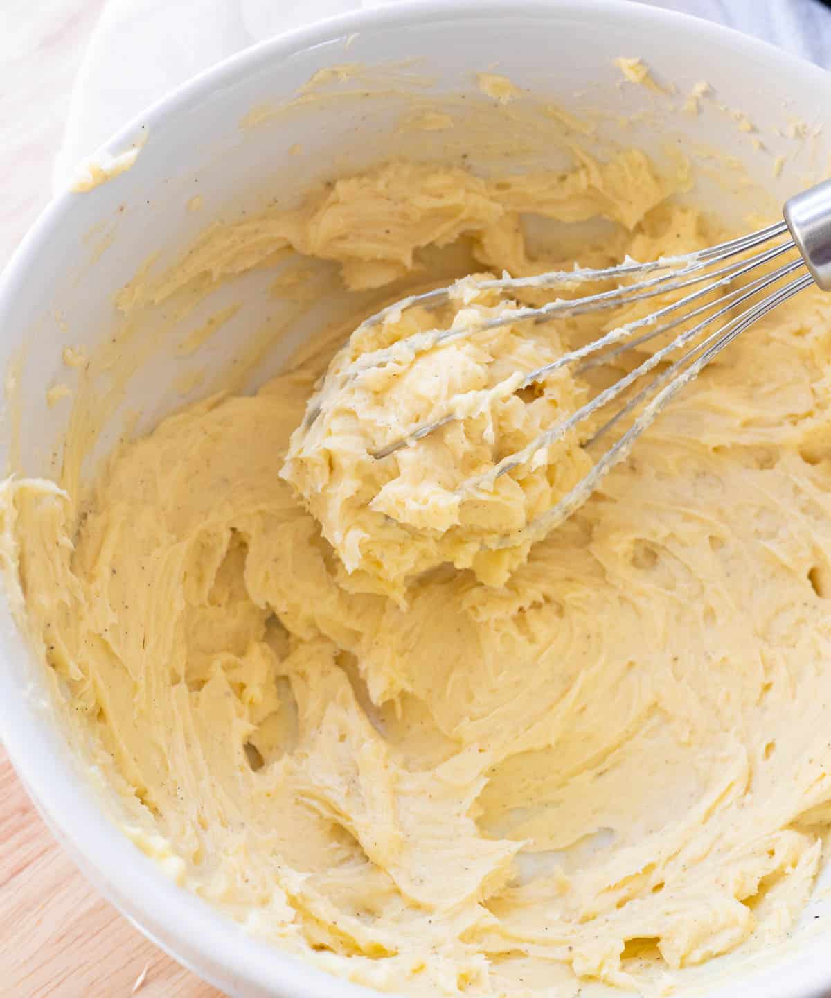 Whipped honey butter in white mixing bowl.