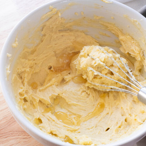 Whipped honey butter in white mixing bowl.