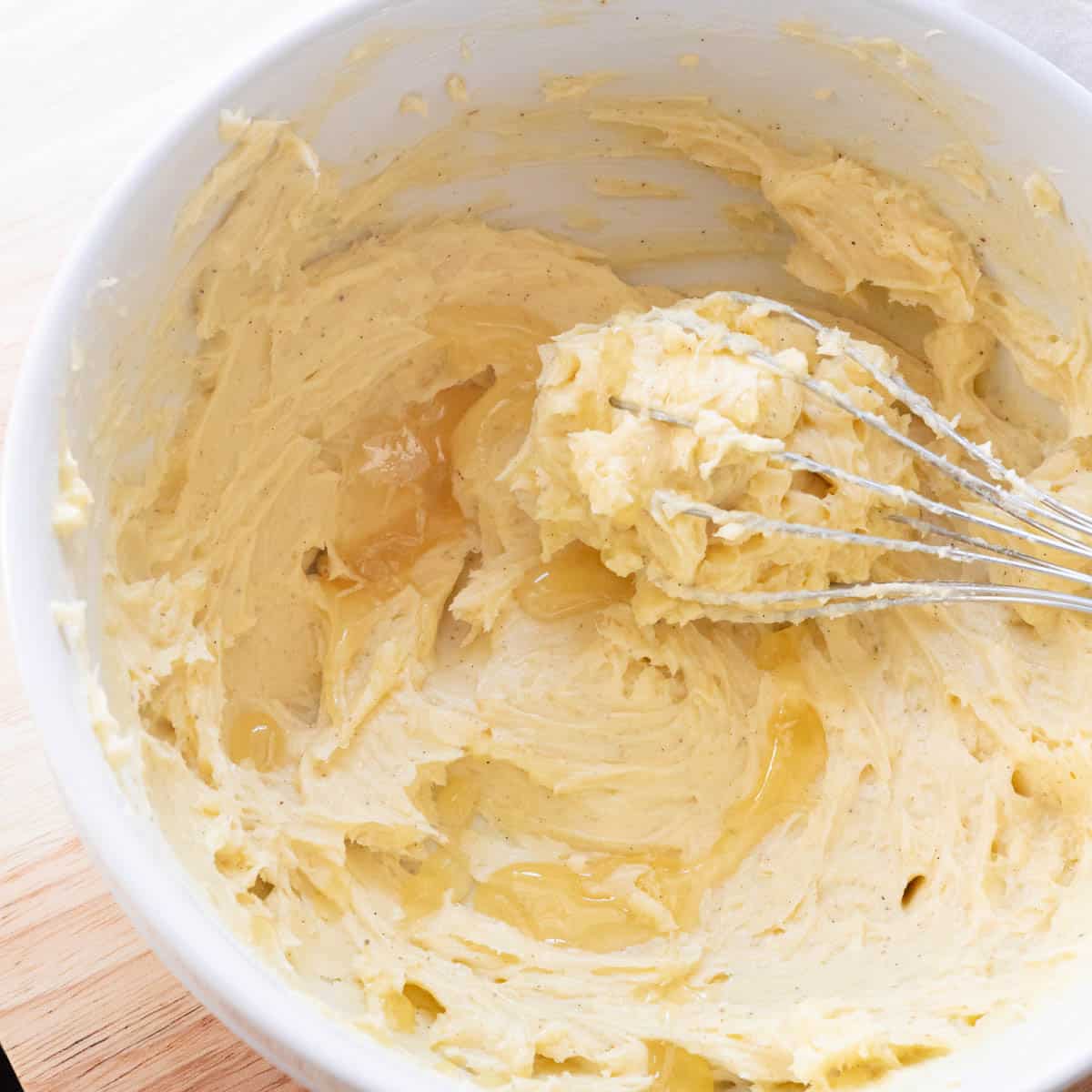 Whipped honey butter in white mixing bowl.