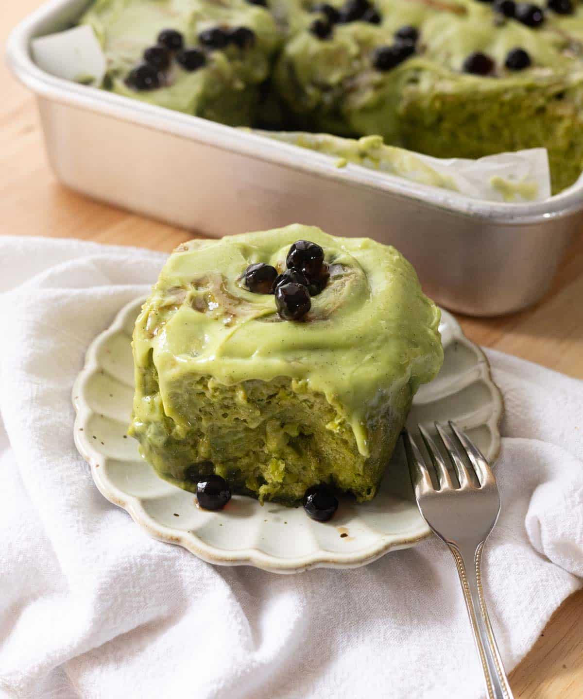 Brown sugar boba matcha rolls on a fluted plate, topped with extra boba.