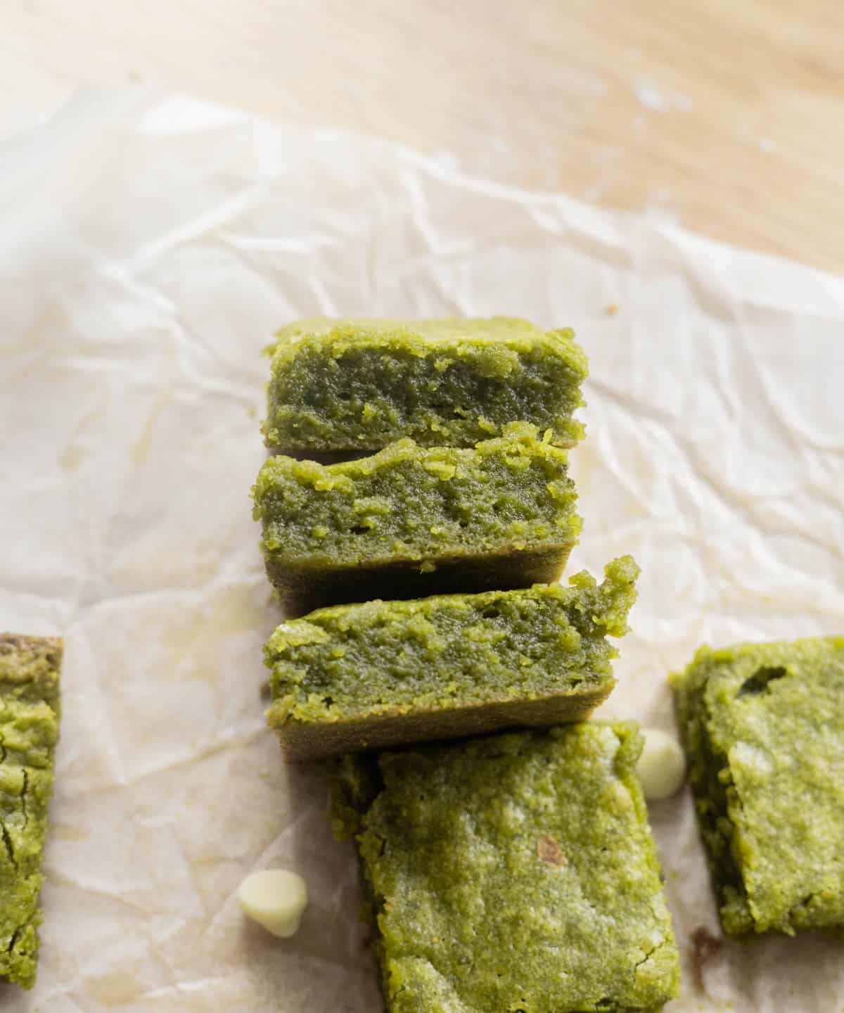 Fudgy matcha brownies on parchment paper.