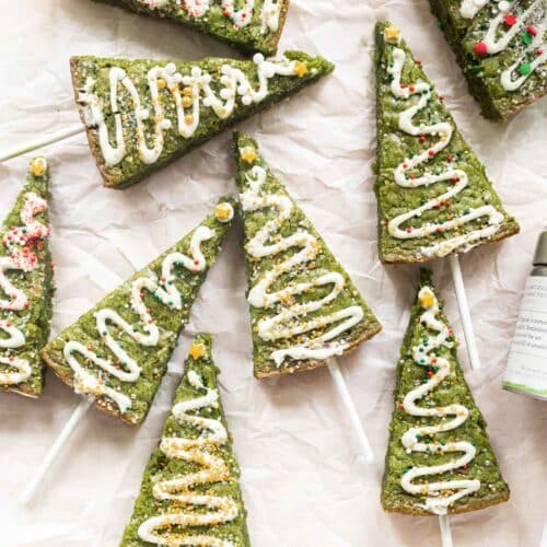 Matcha Christmas tree brownies decorated with white chocolate and sprinkles.