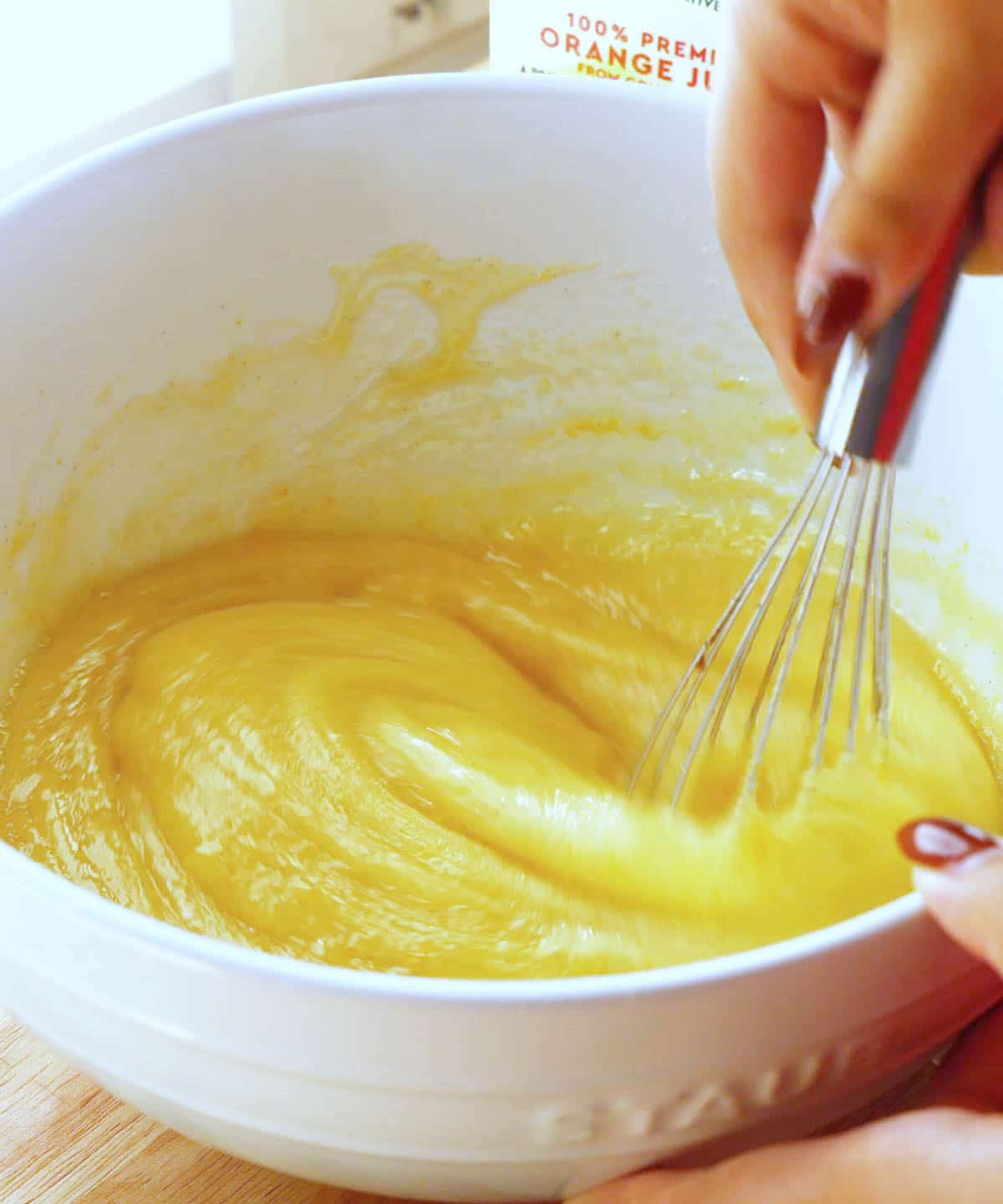 Olive oil cake batter in white bowl.