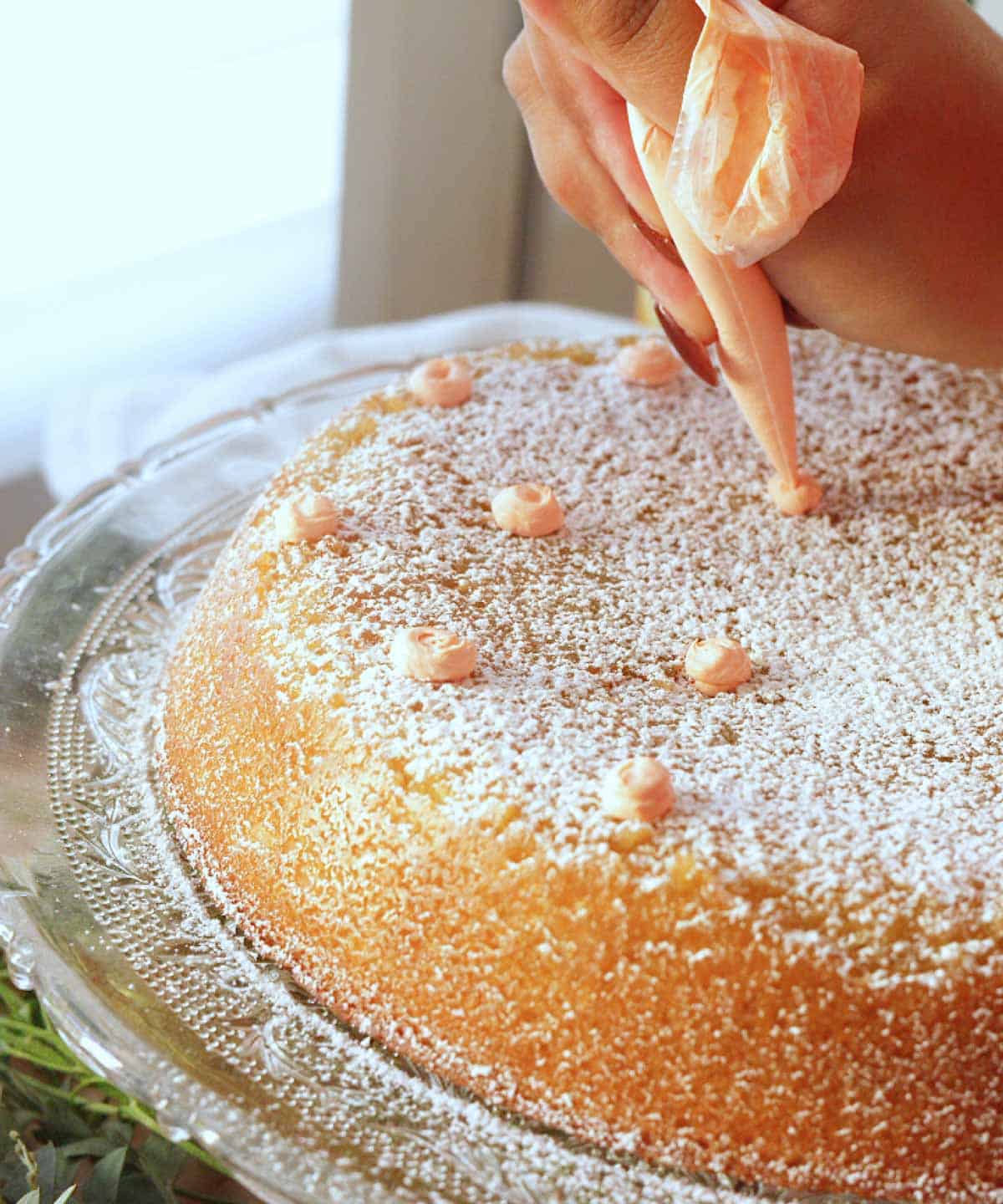 Adding decorations to orange olive oil cake.