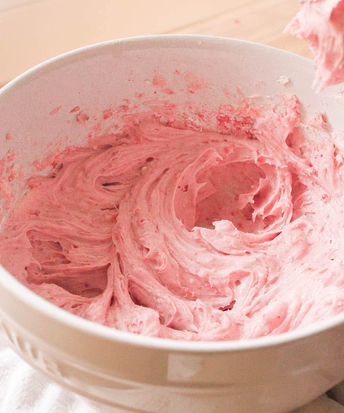 Thick strawberry cream cheese frosting, ready for heavy cream.