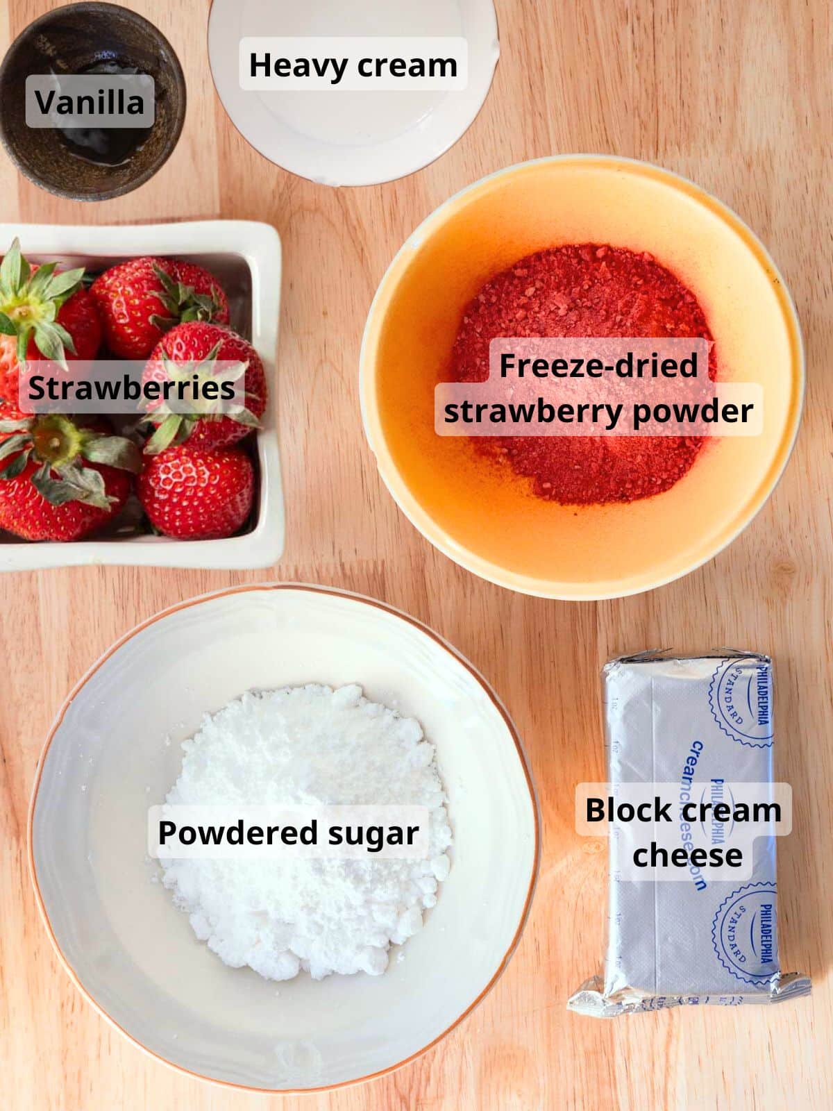 Labeled strawberry cream cheese frosting ingredients laid out on a table.