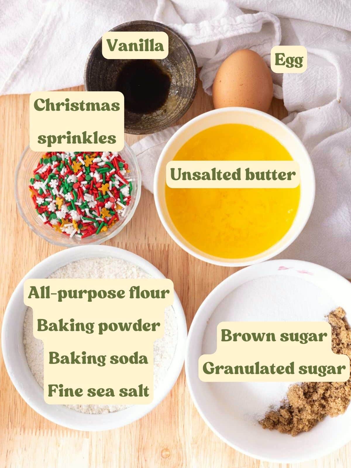 Christmas sprinkle cookie ingredients laid out on a table.