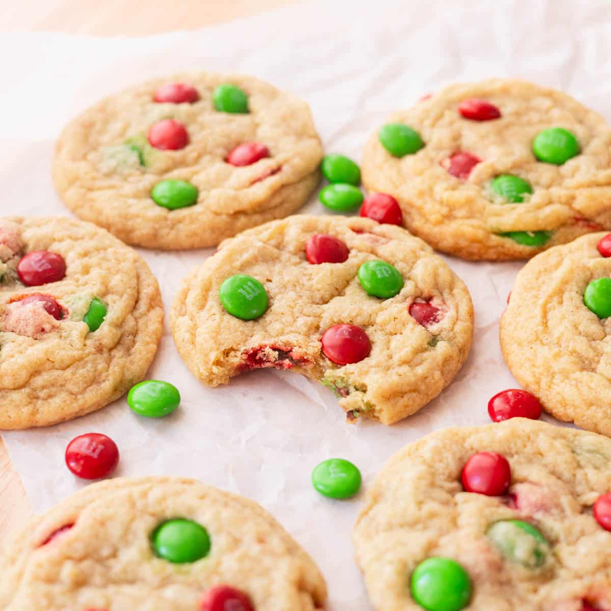 Christmas M&M cookies on parchment paper.