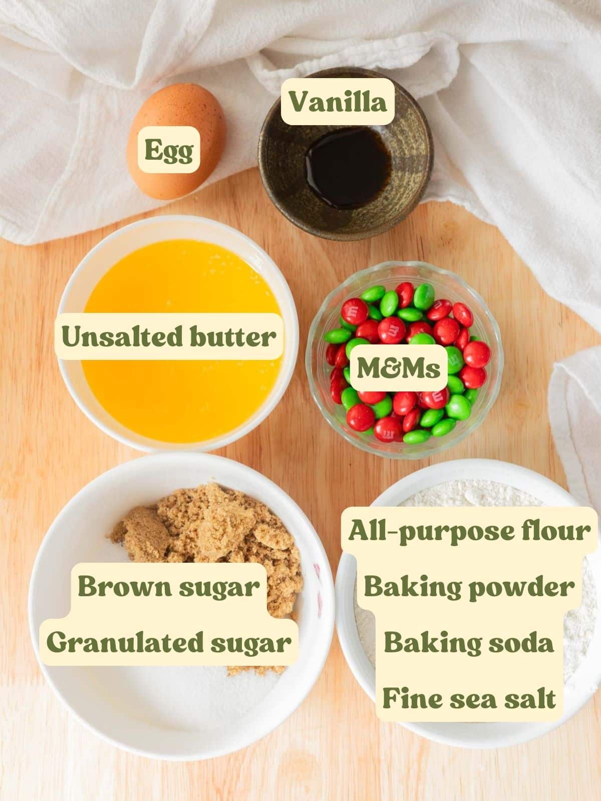 Christmas M&M cookie ingredients laid out on a table.