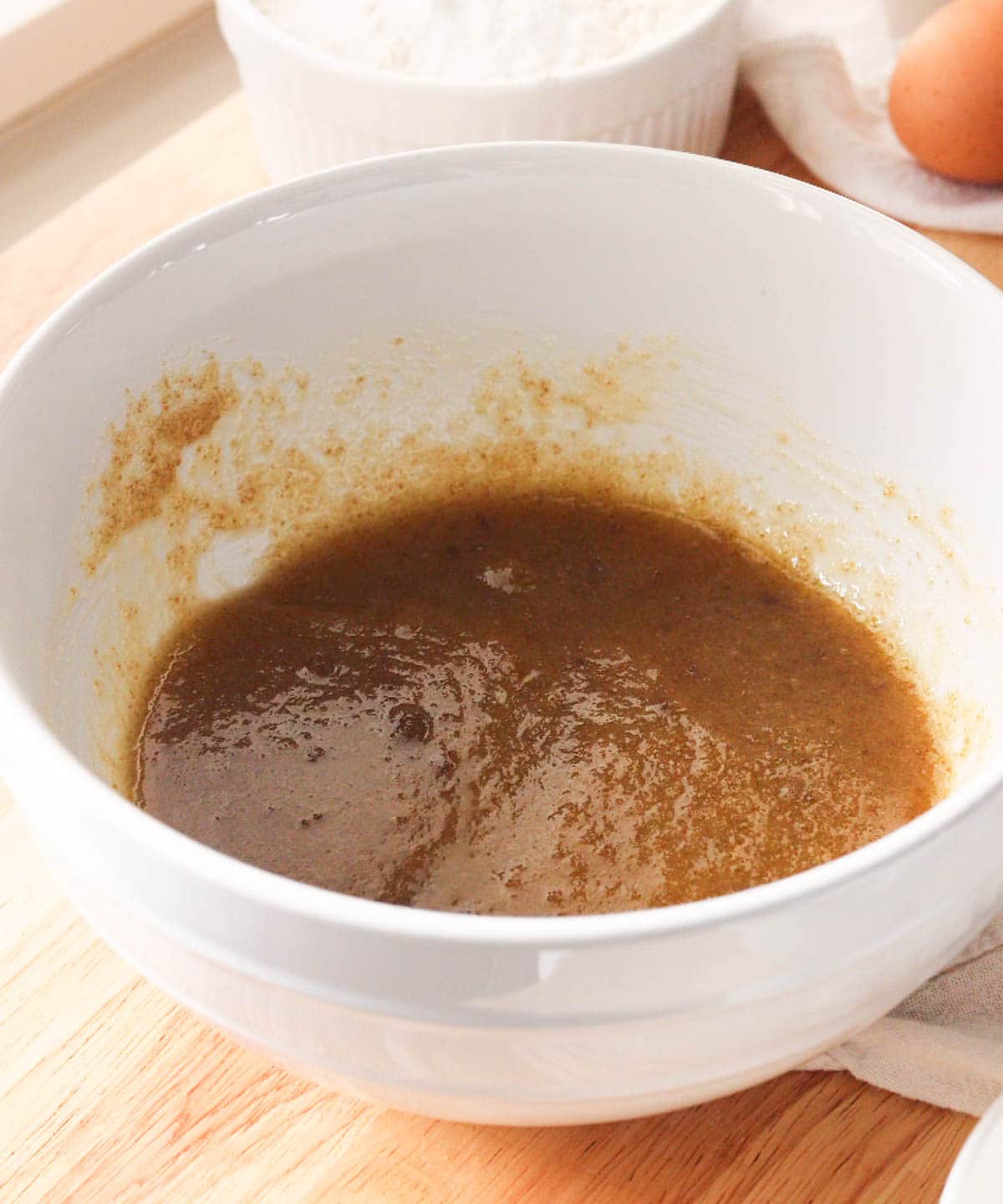 Mixed butter and sugars in a bowl.