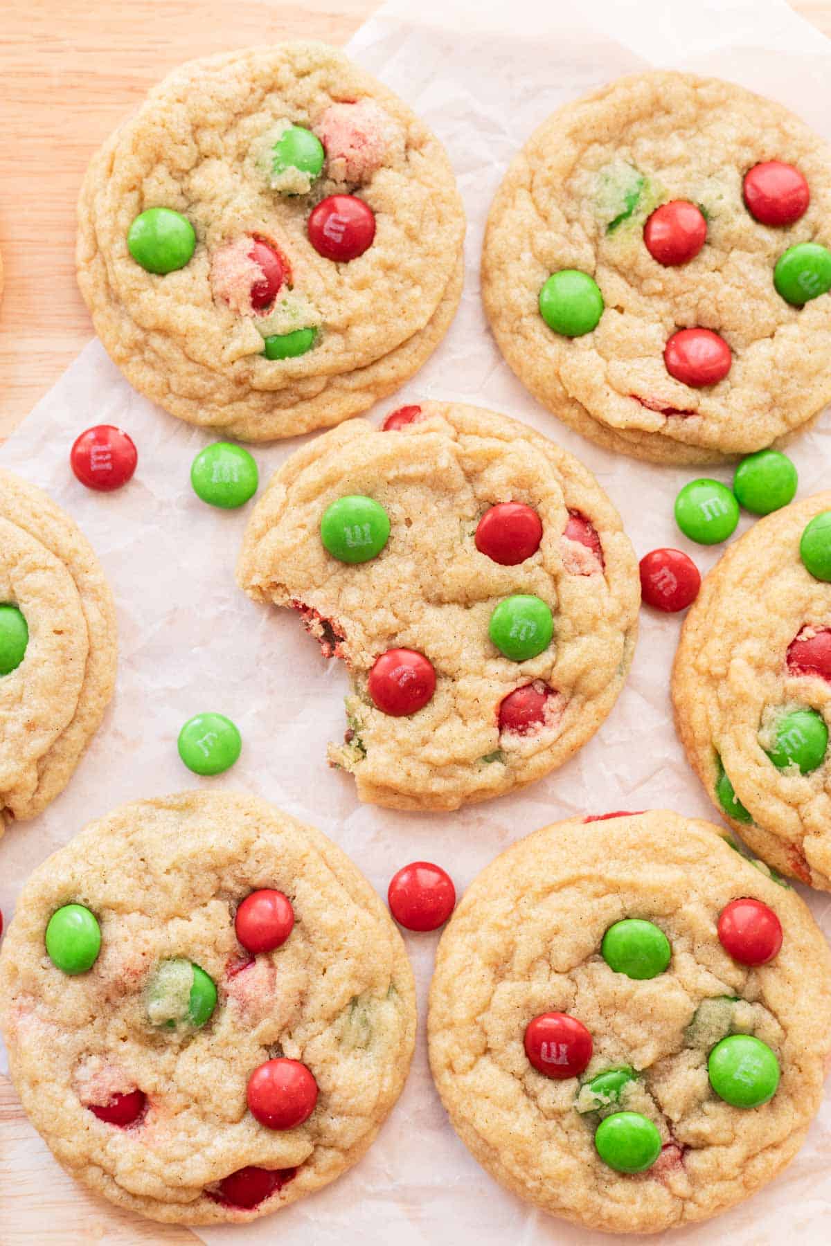 Christmas M&M cookies on parchment paper.