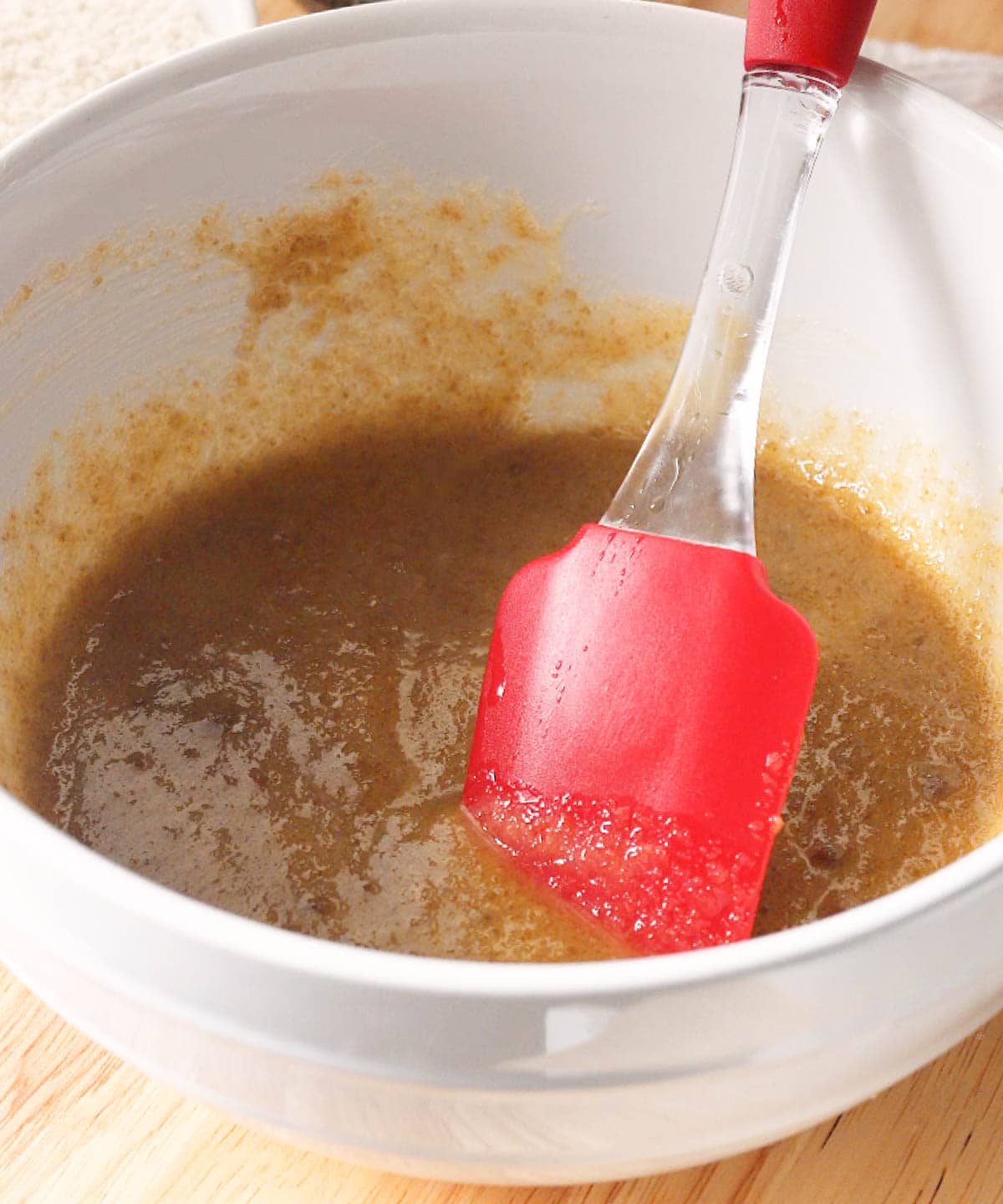 Mixed butter and sugars in a bowl.