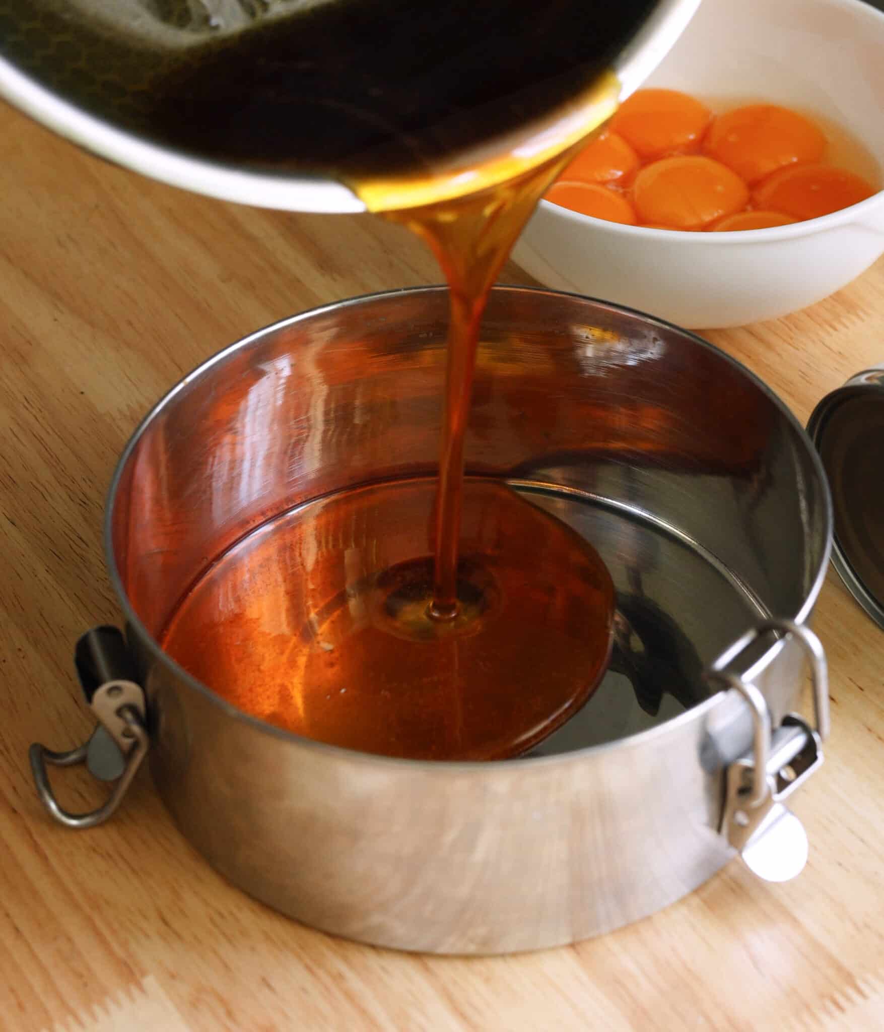 Pouring caramel into llanera for leche flan.