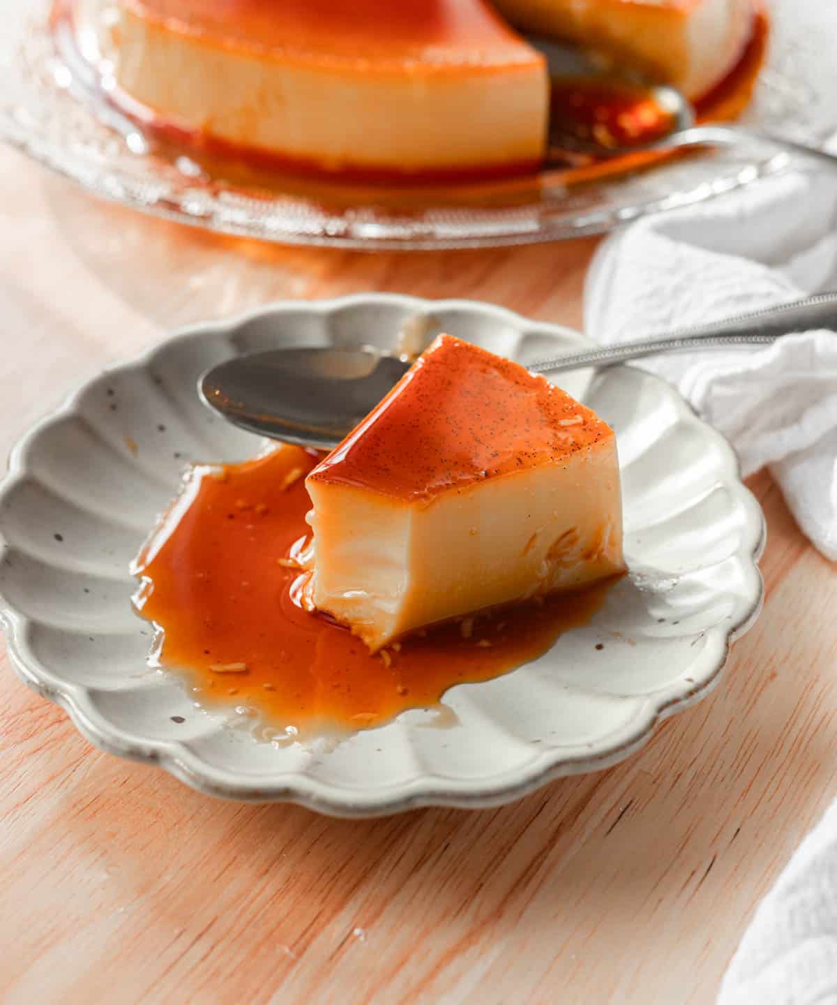 Slice of flan with a bite taken out of it.