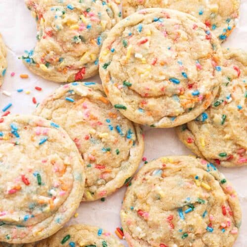 Funfetti sprinkle cookies on white parchment paper.