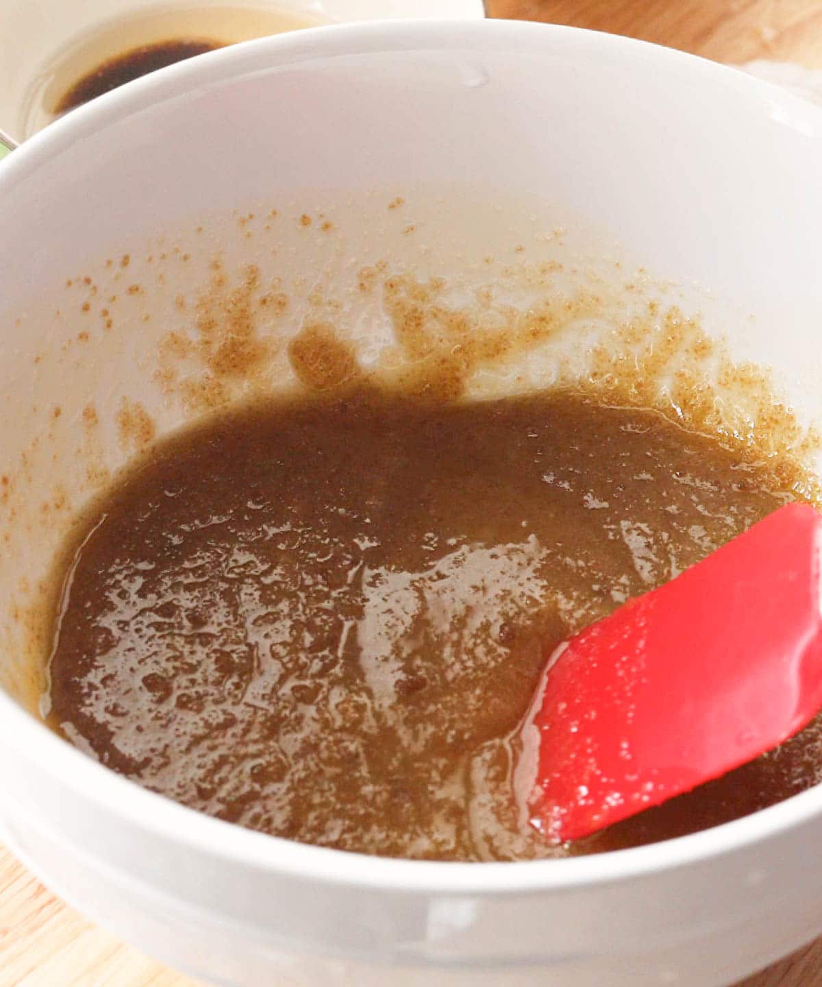 Mixed butter and sugars in a bowl.