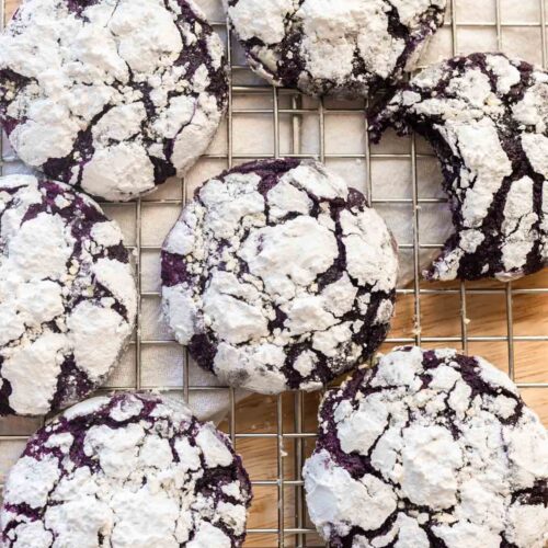 Purple ube crinkle cookies on a wire rack.