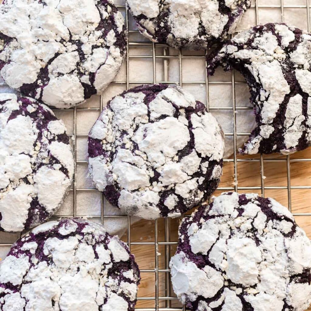 Purple ube crinkle cookies on a wire rack.