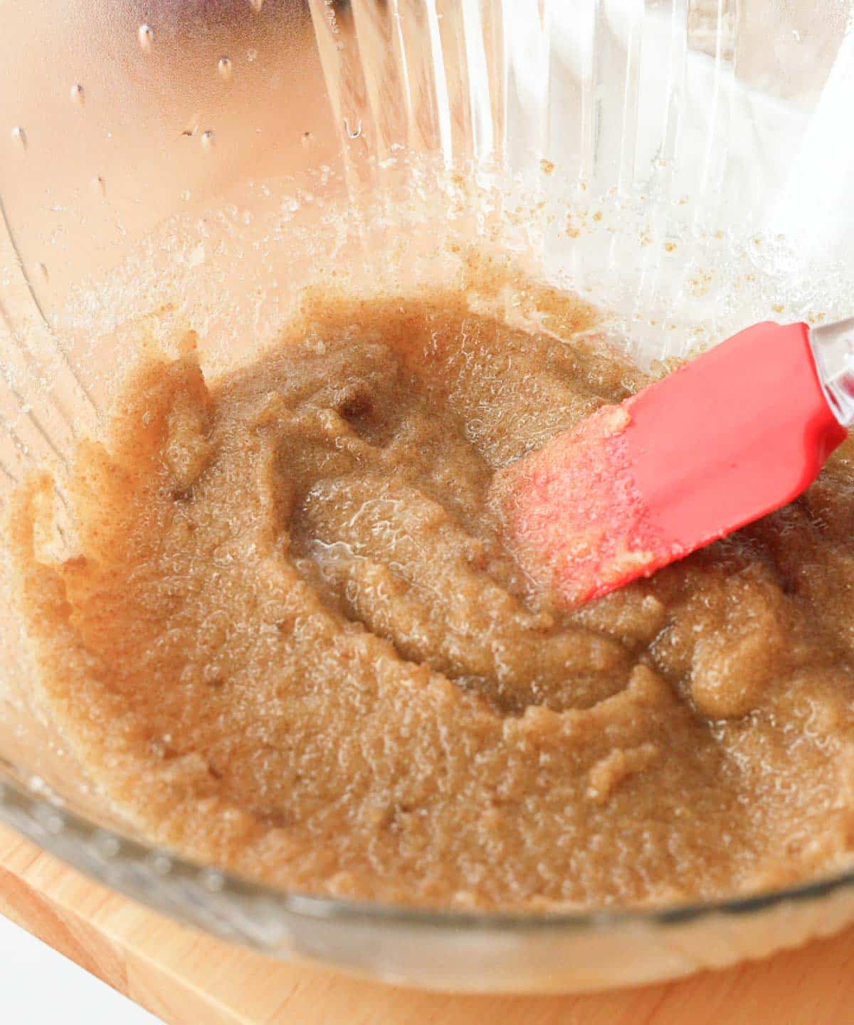 Mixed butter and sugars in glass mixing bowl.