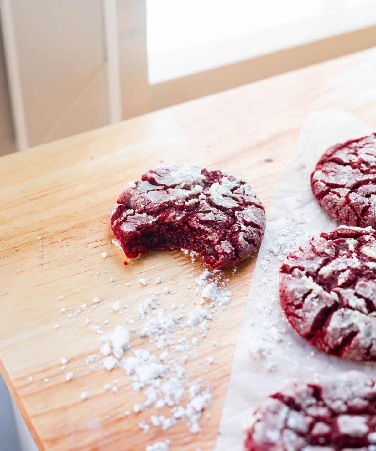 Red velvet cookie with a bite taken out of it, showing the soft fudgy middle.