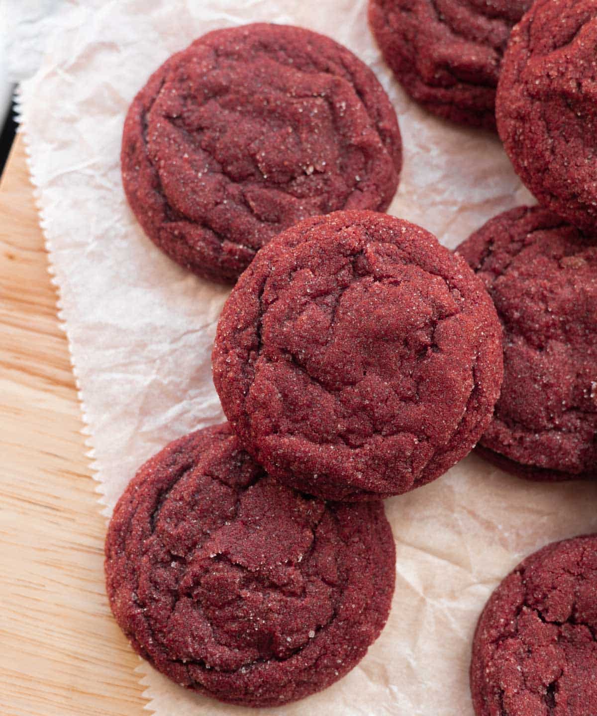 Red velvet sugar cookies on parchment paper.