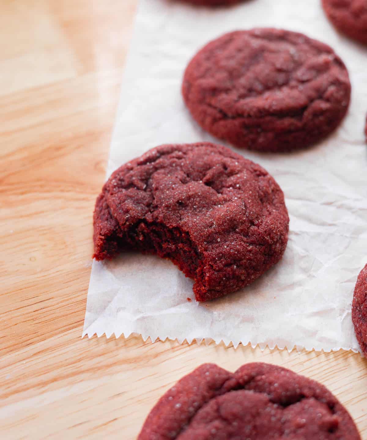 Red velvet sugar cookies on parchment paper.