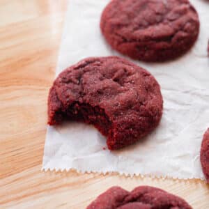 Red velvet sugar cookies on parchment paper.