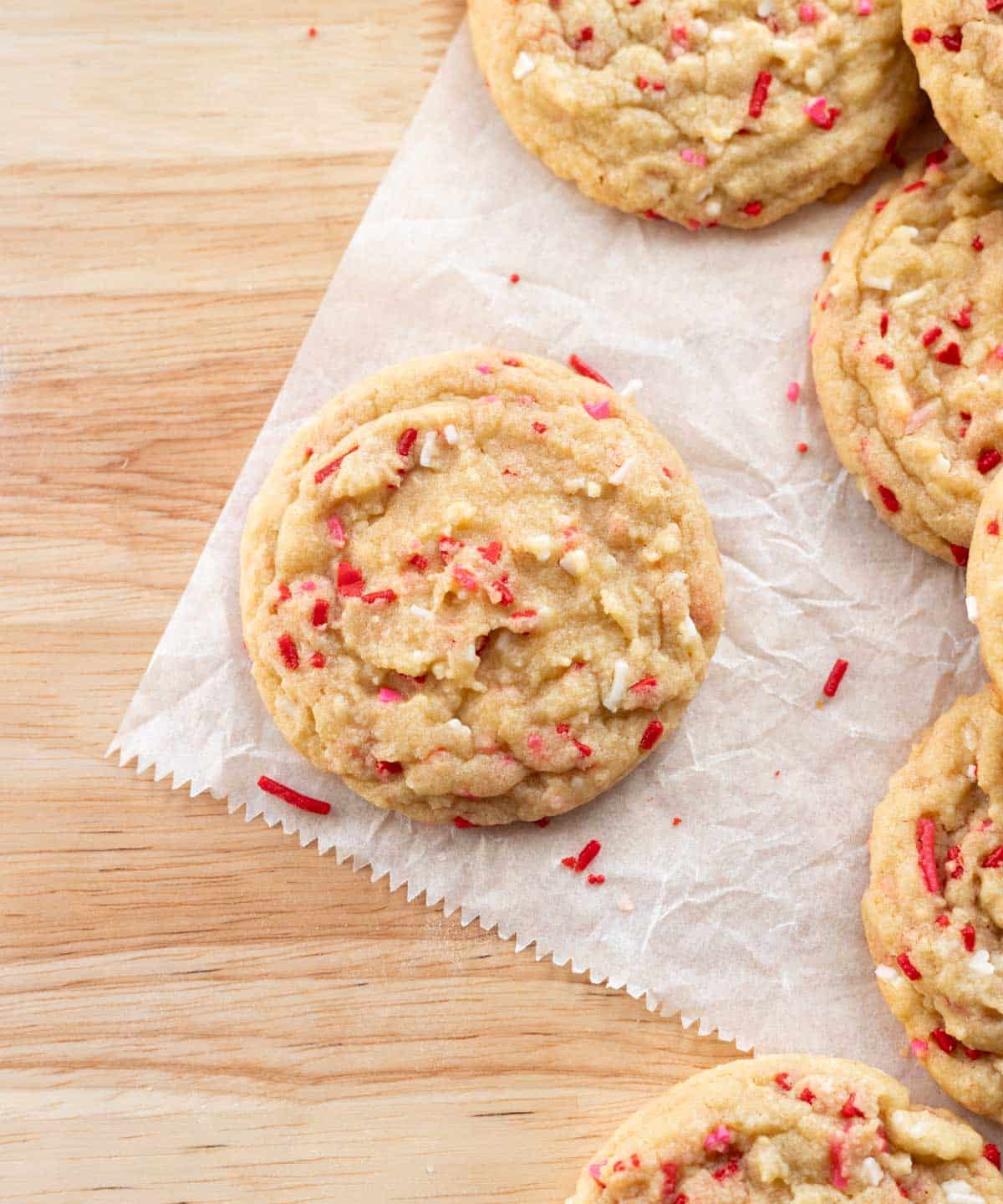 Valentine's Day sugar cookies on white parchment paper.