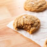 Peanut butter cookie with a bite taken out of it.