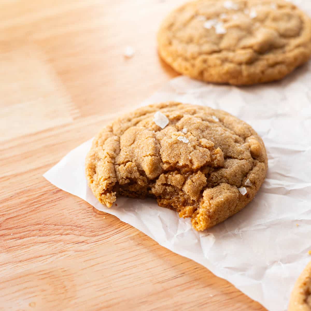 Peanut butter cookie with a bite taken out of it.