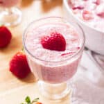 Pink strawberry sago in a glass cup with a strawberry heart on top.