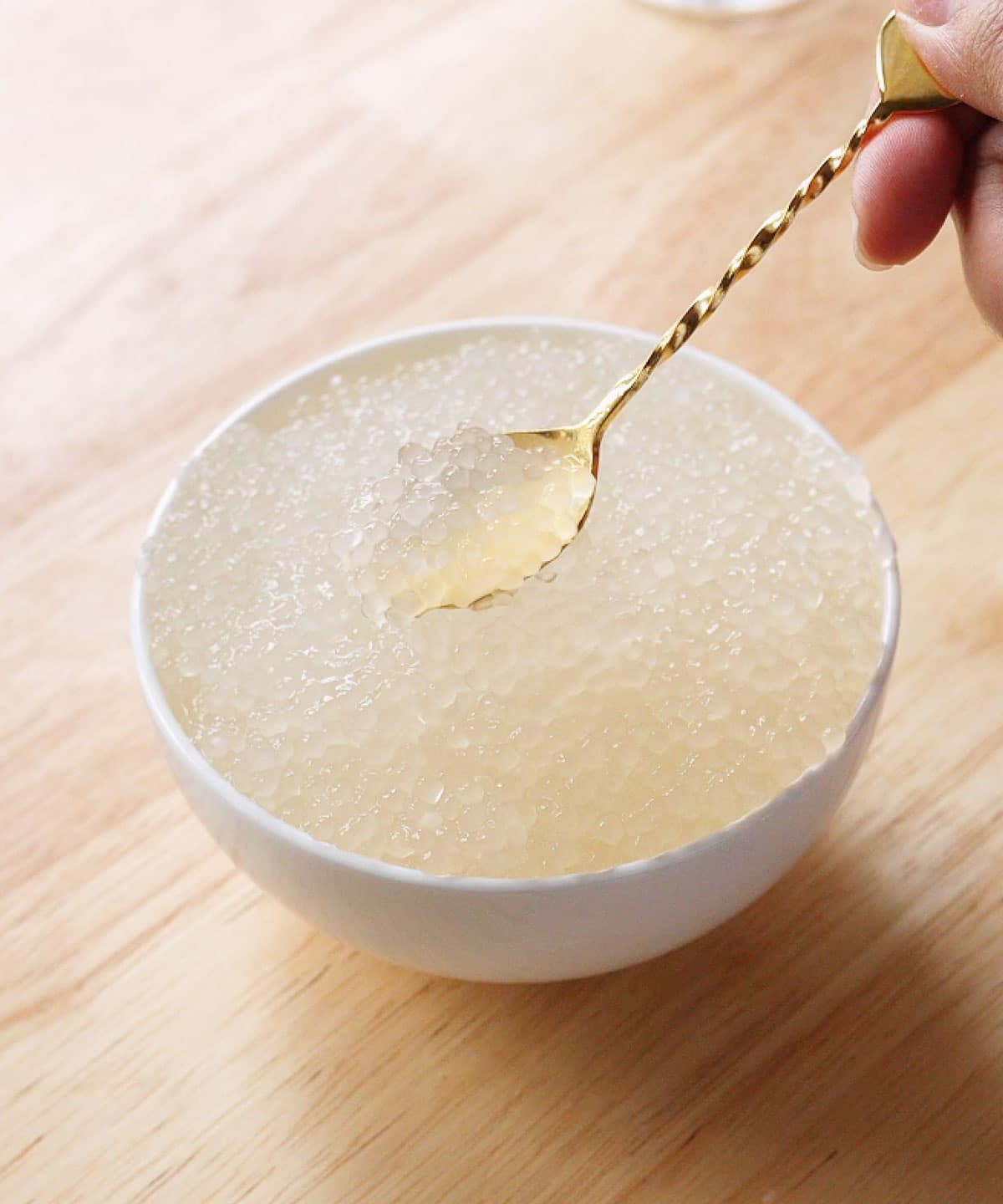 Cooked tapioca pearls in a white bowl.