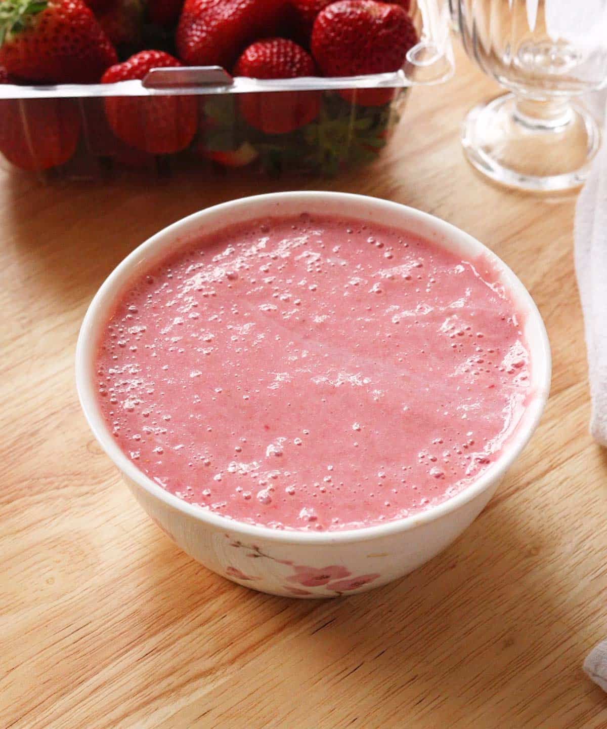 Blended strawberries and sweetened condensed milk in a bowl.