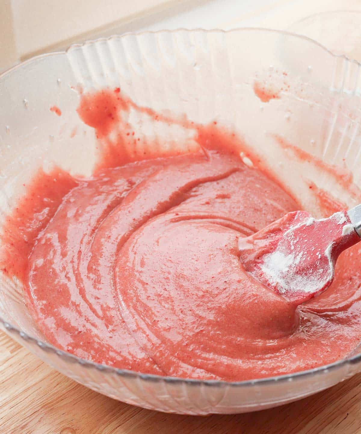 Mixed strawberry brownie wet ingredients in a glass bowl.