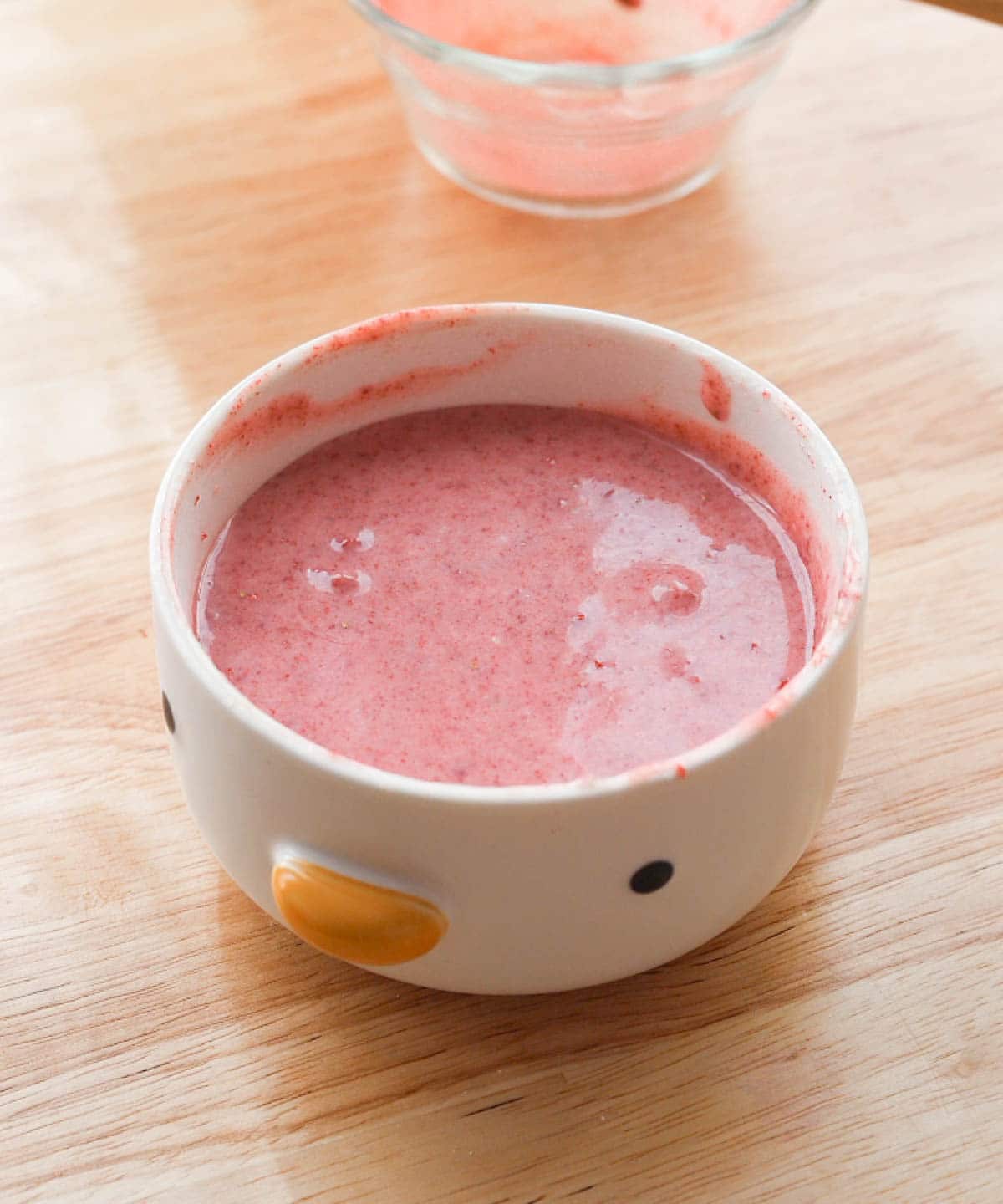 Melted strawberry ganache in a microwave-safe bowl.