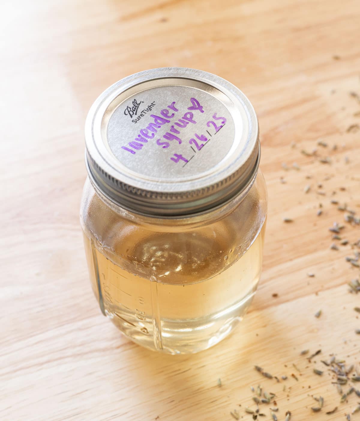 Homemade lavender syrup in a glass jar.
