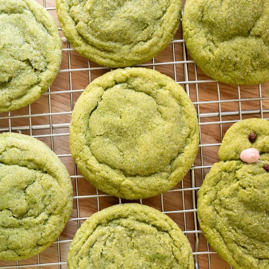 Soft matcha sugar cookies on a wire rack.