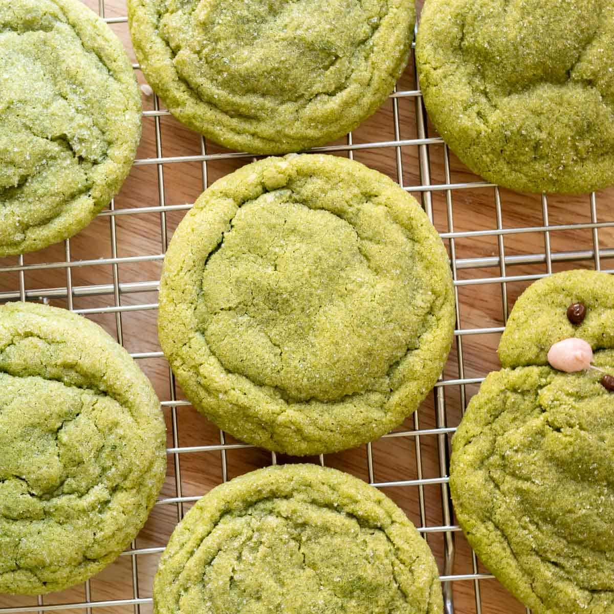Soft matcha sugar cookies on a wire rack.