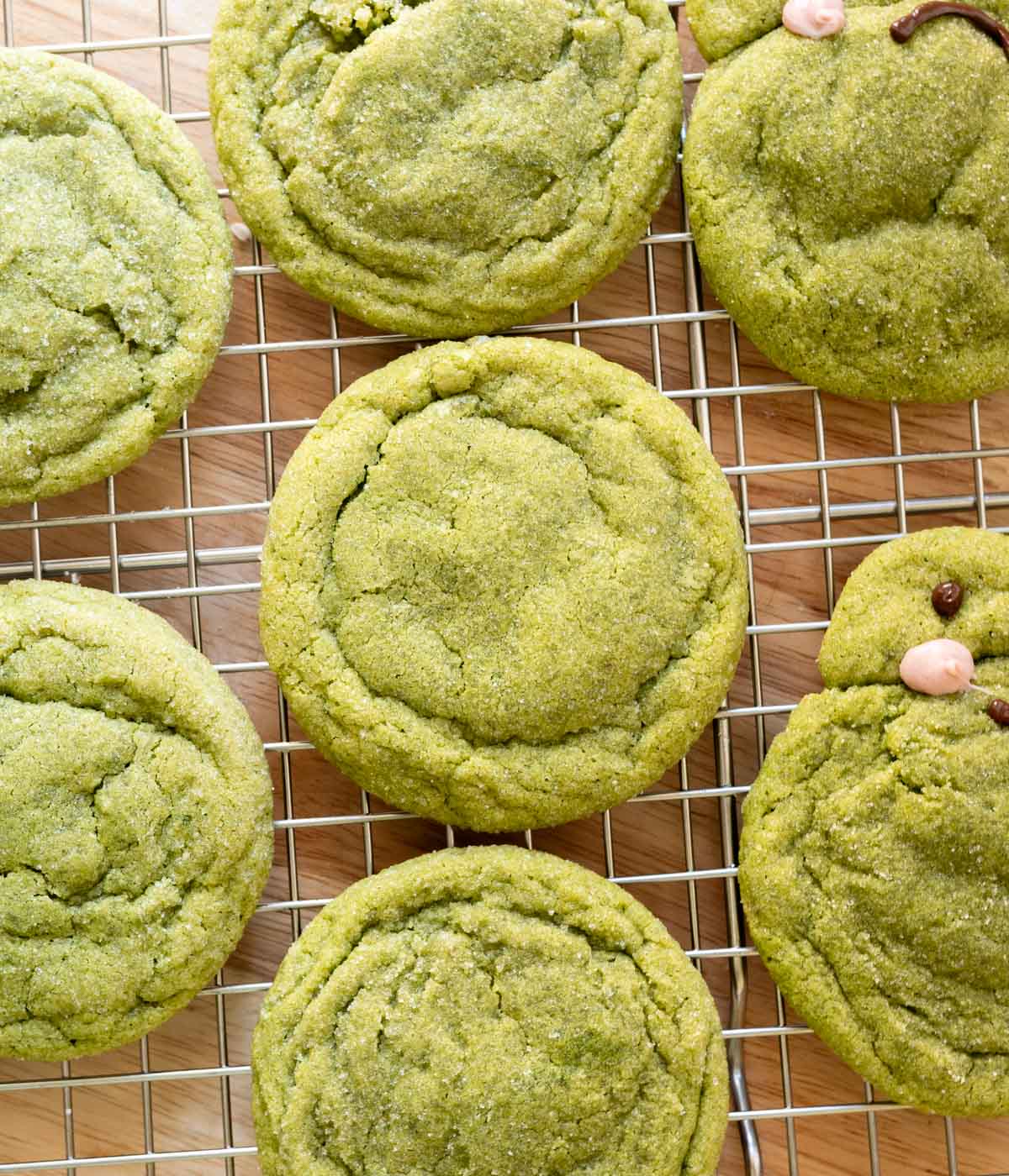 Soft matcha sugar cookies on a wire rack.