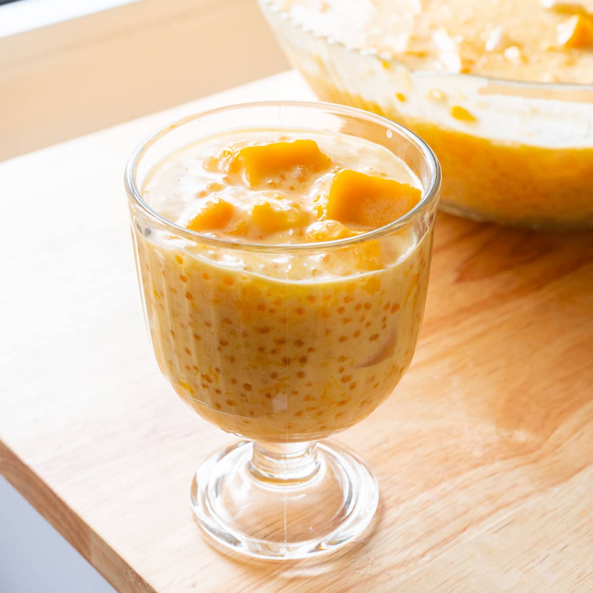 Mango sago in a glass cup.