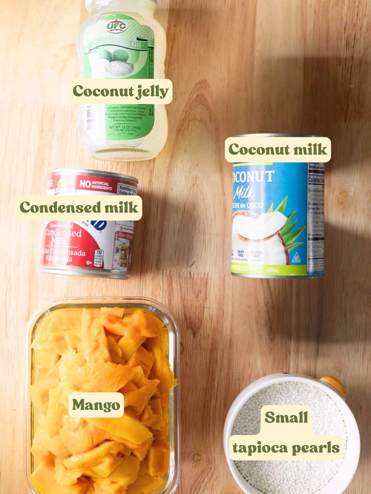 Mango sago labeled ingredients on a wooden table.