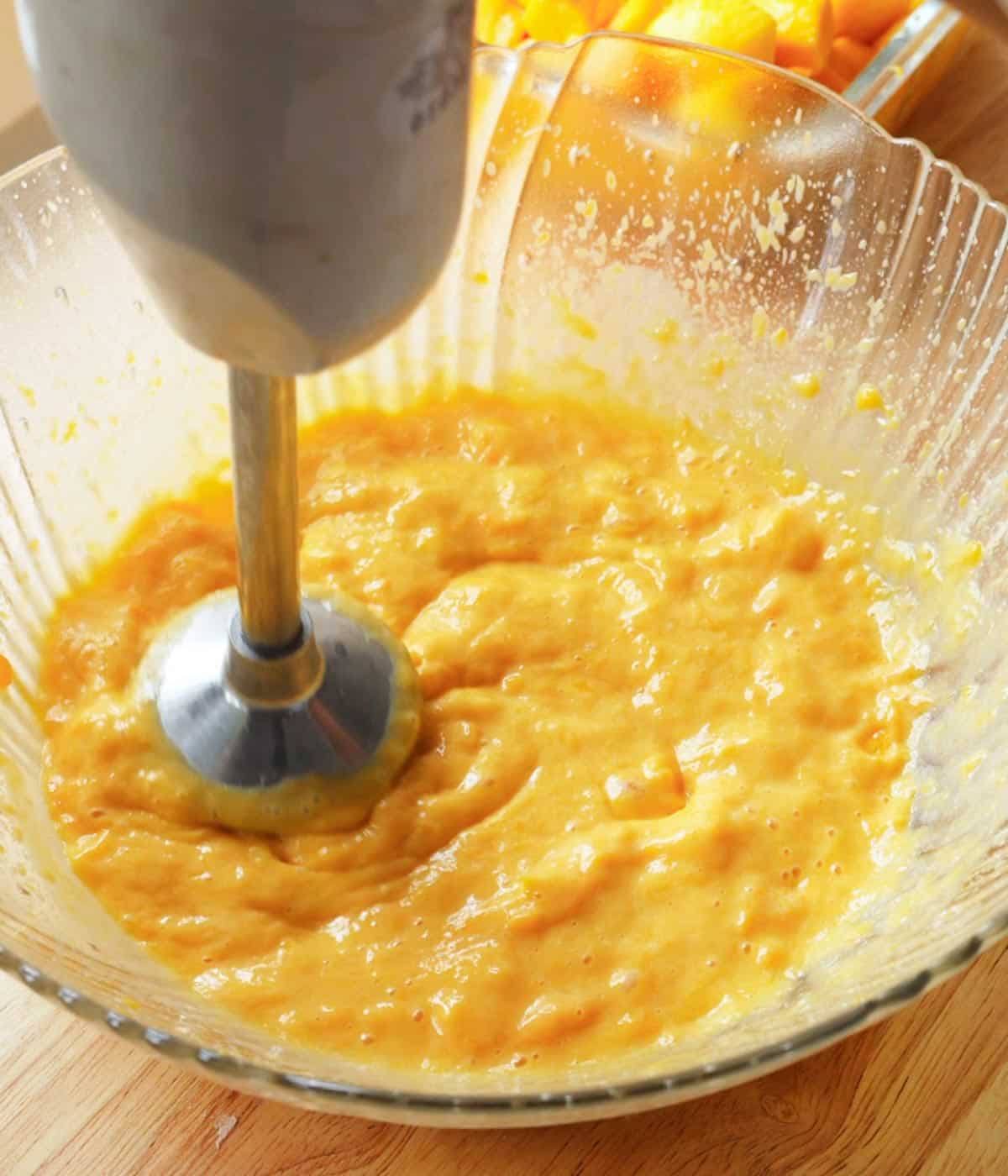 Blended mangoes and sweetened condensed milk in a bowl.
