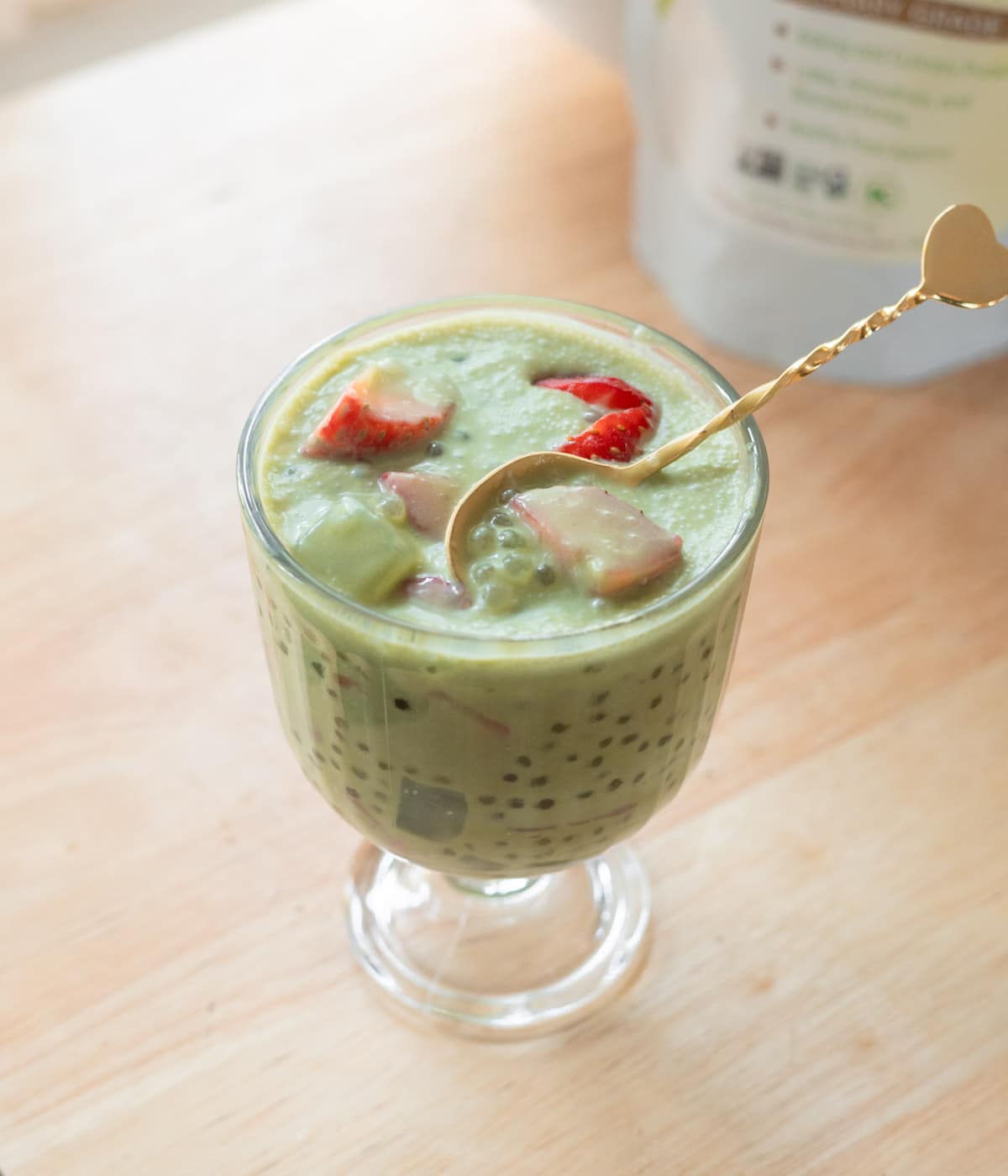 Strawberry matcha latte sago in a glass serving cup.