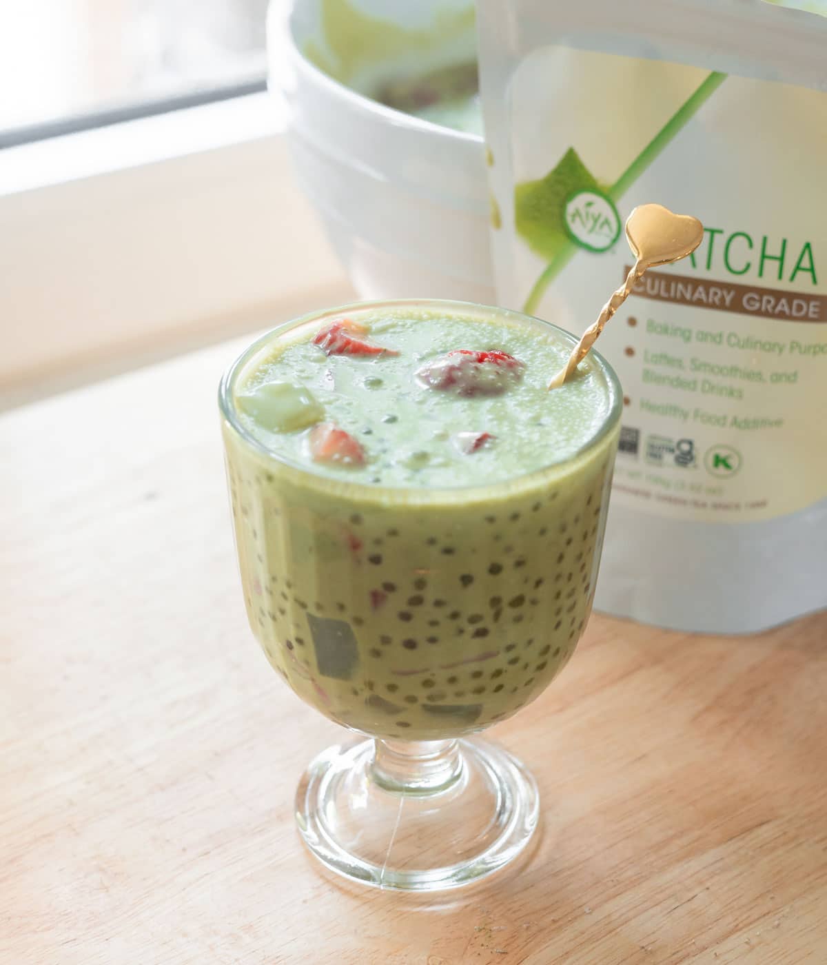 Matcha sago in a glass serving cup.