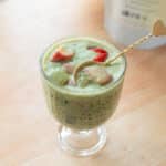 Strawberry matcha latte sago in a glass serving cup.