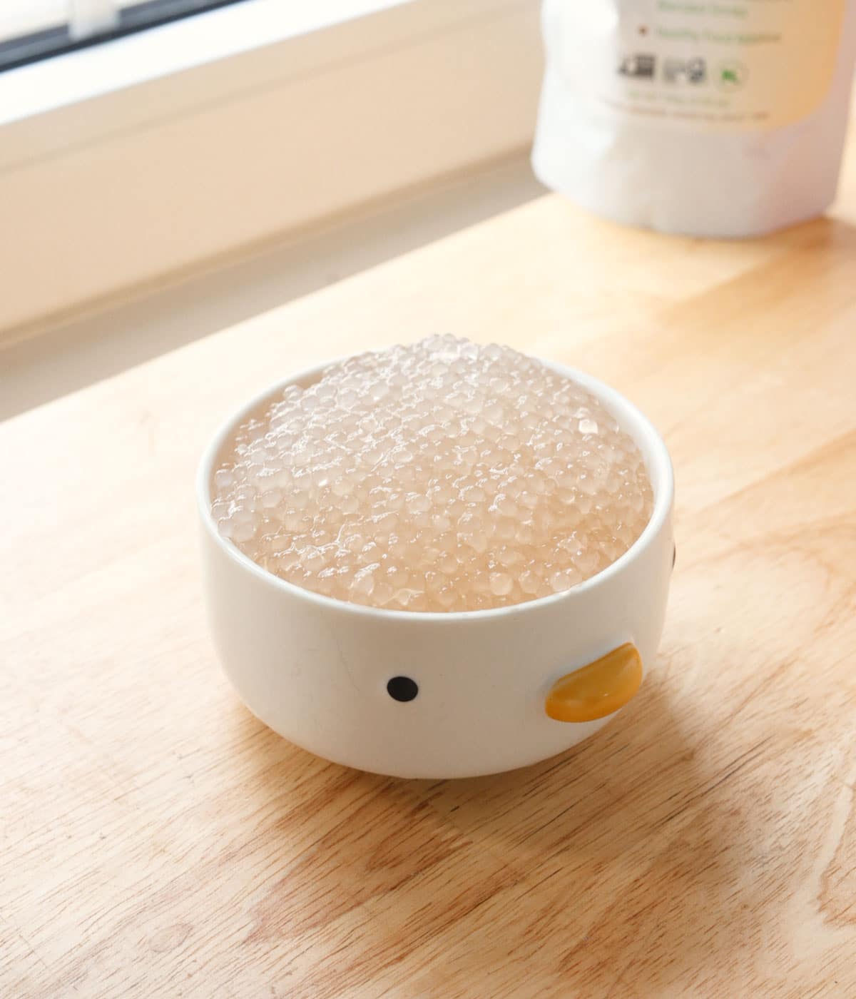 Cooked small tapioca pearls in a white bowl.