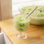 Buko pandan in a glass serving cup on a wooden table.